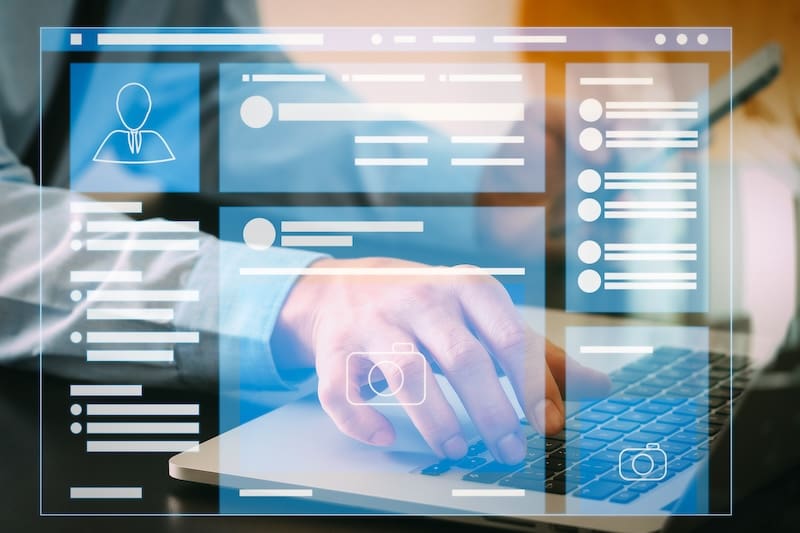 A man is using a laptop with social media icons and removing Google reviews.