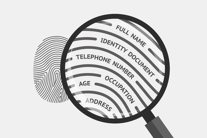 A magnifying glass revealing personal information.