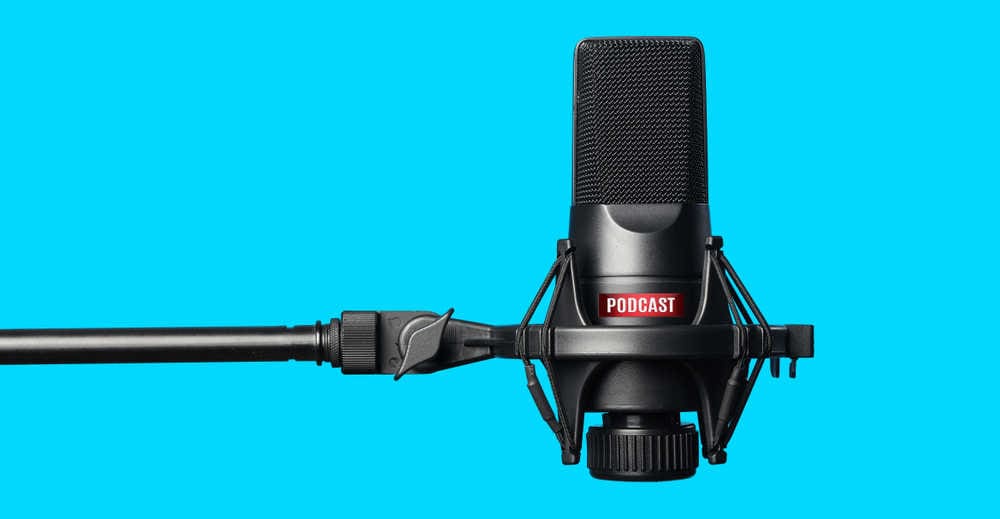 Podcast microphone on a blue background.