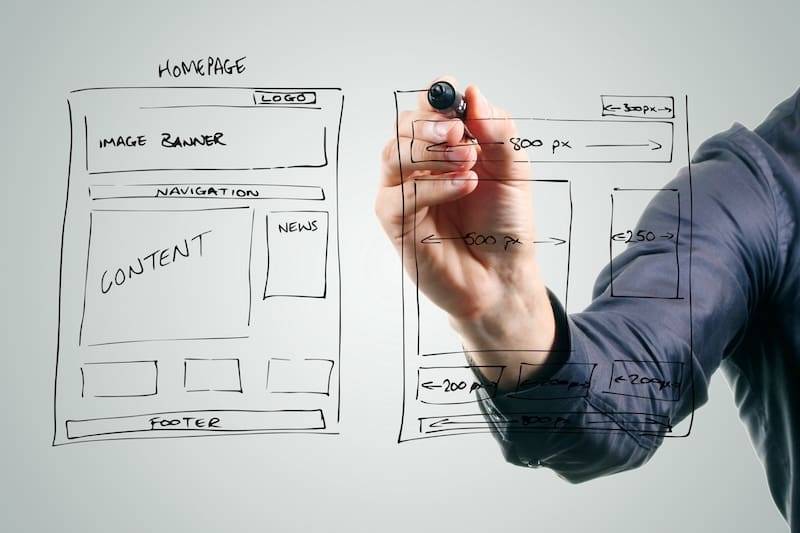 Designer drawing website development wireframe.